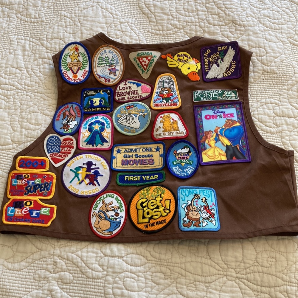 Y2K vintage Girl Scout Brownie vest with patches and pins.